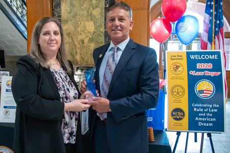 Chief Judge Robert Villa (right) presents the first annual 16th Judicial Circuit Law Day Spirit Award to Kane County attorney Julie Cibulskis (left). The award is given in recognition of an individual (or individuals) who exemplify the principles of the