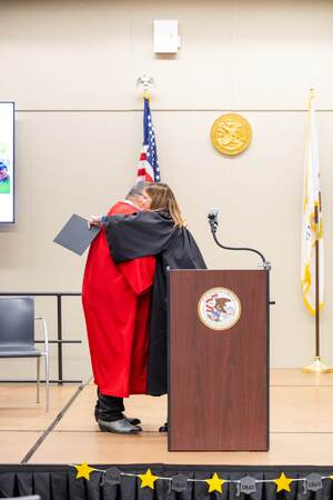 Judge Downs congratulates a Drug Rehabilitation Court graduate.