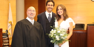 Judge William Engerman poses with couple after performing their wedding ceremony