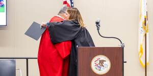 Judge Downs congratulates a Drug Rehabilitation Court graduate.